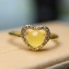 A 15-year-old store has a heart-shaped ring with a white jade crystal bead, amber and copper setting Specification image